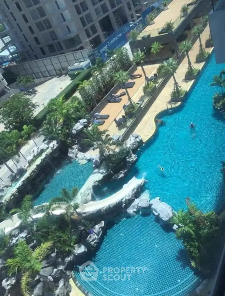 Luxurious residential complex with stunning outdoor pool and lush landscaping