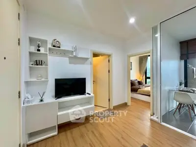 Modern apartment interior with cozy living room and stylish bedroom, featuring wooden flooring and contemporary decor.