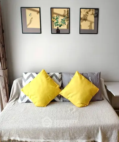 Cozy living room with stylish decor and vibrant yellow cushions.