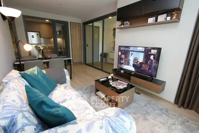 Modern living room with open kitchen, stylish decor, and cozy ambiance