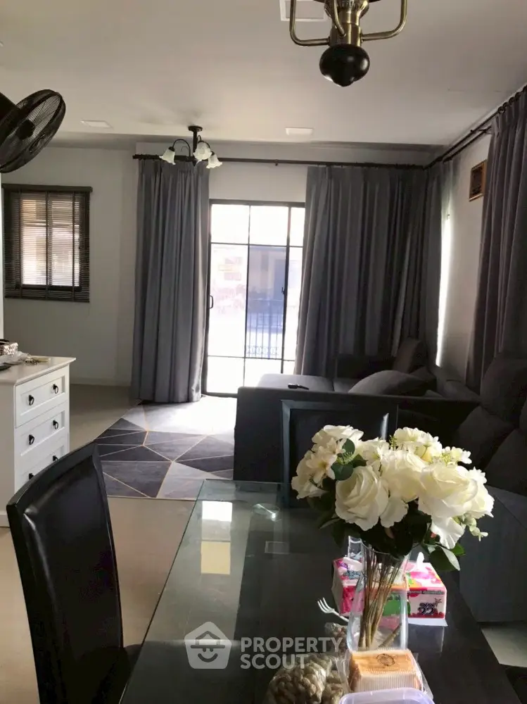 Elegant living room with modern decor and large windows for natural light.