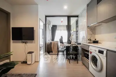 Modern apartment interior with open kitchen and living area featuring washing machine and stylish decor.