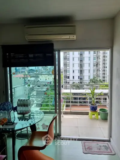 Modern apartment with balcony offering city views and stylish interior design.