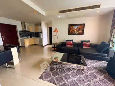 Spacious modern living room with stylish decor and open kitchen layout.