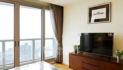 Modern bedroom with city view, large windows, and stylish decor in high-rise apartment.