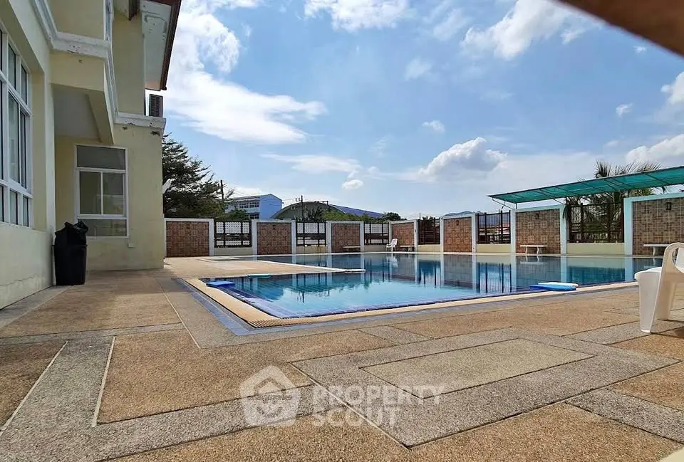 Luxurious outdoor pool area with clear blue skies and modern design, perfect for relaxation and leisure.