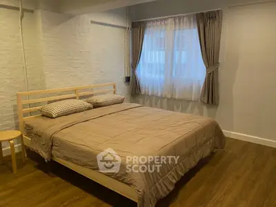 Cozy bedroom with wooden flooring and modern decor