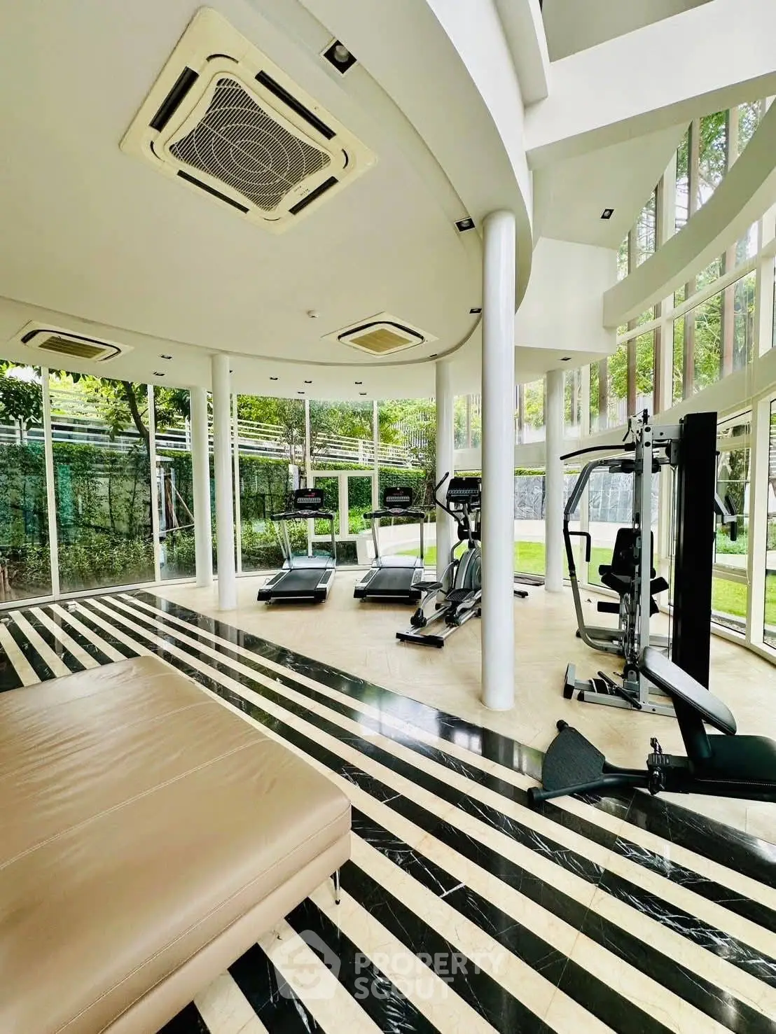 Luxurious home gym with modern equipment and garden view