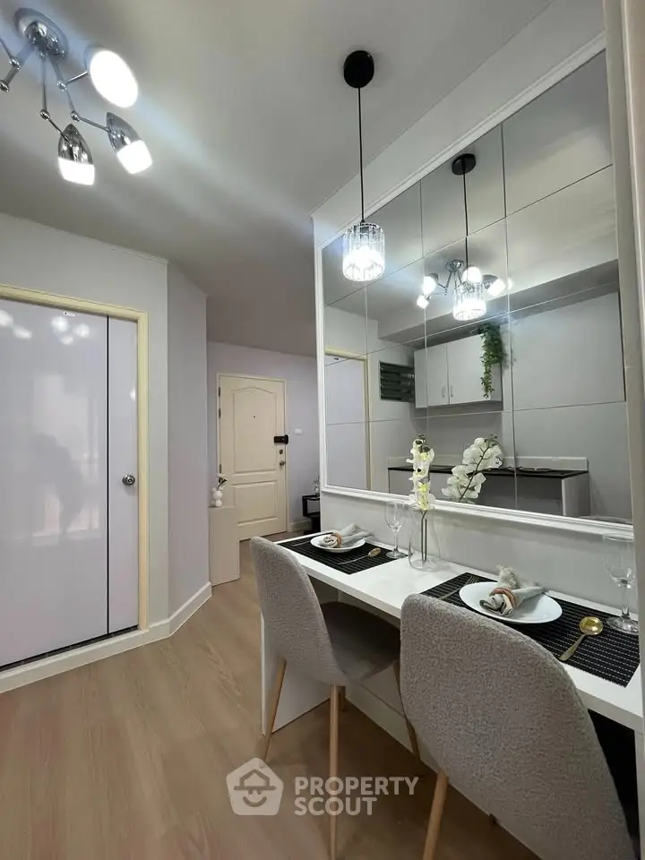 Modern dining area with elegant decor and mirrored wall in stylish apartment