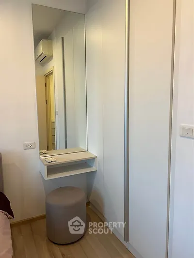 Modern bedroom with built-in wardrobe and vanity mirror