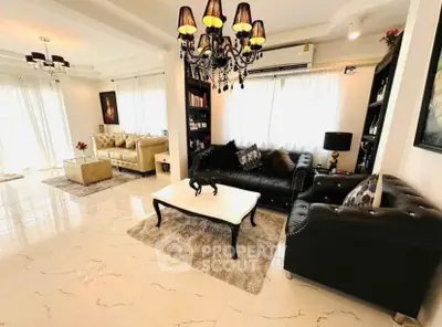 Luxurious living room with elegant chandeliers and plush leather sofas