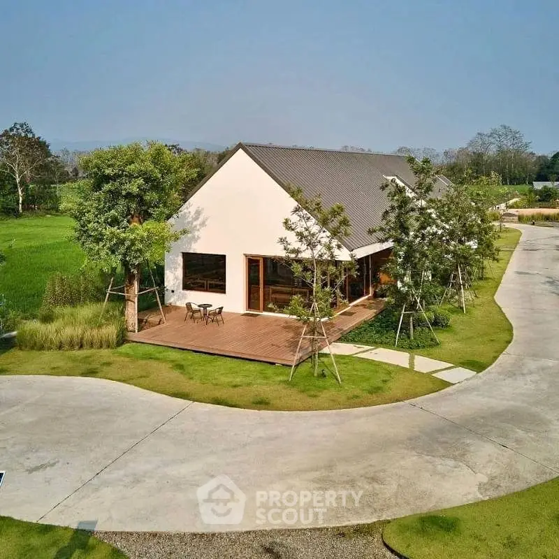 Charming modern house with spacious deck and lush greenery, perfect for serene living.