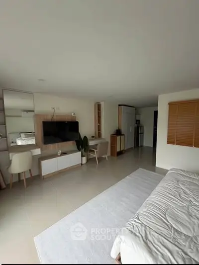 Modern bedroom with sleek furniture and integrated workspace in a bright, minimalist design.