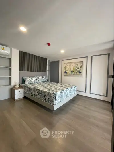 Spacious modern bedroom with stylish decor and ample natural light