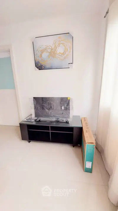 Modern living room with abstract art and sleek TV stand
