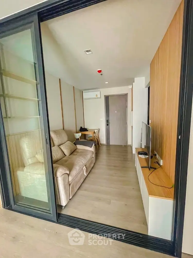 Modern living room with sliding glass doors and cozy sofa