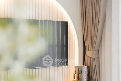Modern living room with sleek TV setup and elegant curtains, perfect for stylish urban living.