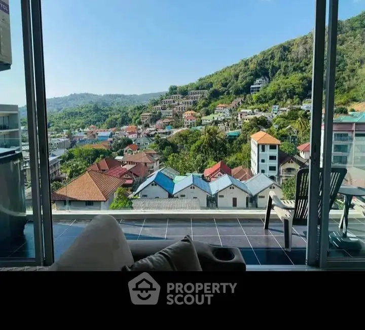 Stunning balcony view overlooking a picturesque hillside neighborhood with lush greenery.