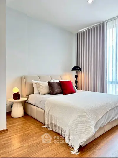 Modern bedroom with stylish decor, cozy bed, and elegant lighting in a bright, inviting space.
