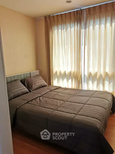 Cozy bedroom with soft lighting and elegant curtains, perfect for relaxation.