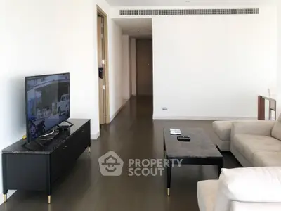 Spacious modern living room with sleek furniture and wooden flooring, perfect for contemporary living.