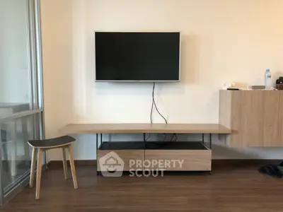 Modern living room with wall-mounted TV and sleek wooden furniture