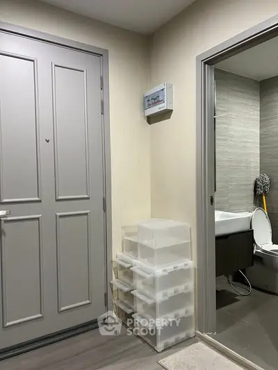 Modern apartment entrance with bathroom view and storage drawers