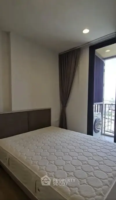 Cozy bedroom with balcony access and natural light in modern apartment