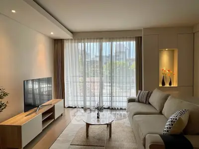 Spacious modern living room with large window and stylish decor