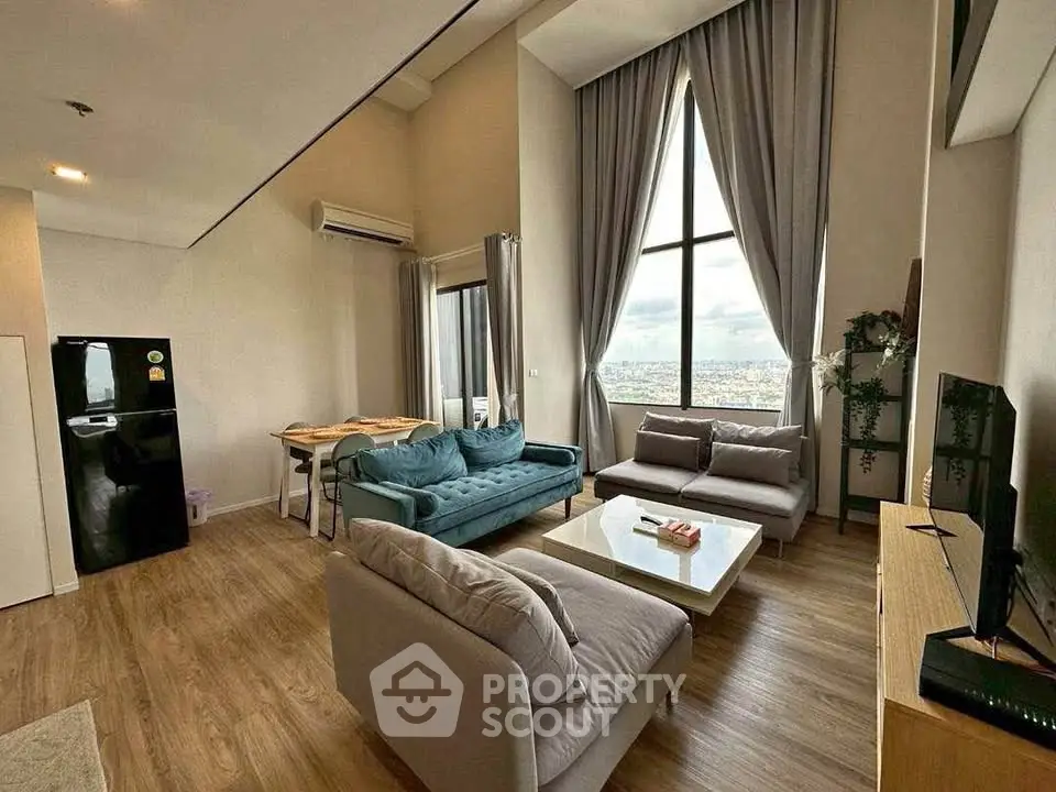 Spacious modern living room with high ceilings and city view