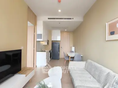 Modern living room with cozy sofa and open kitchen layout