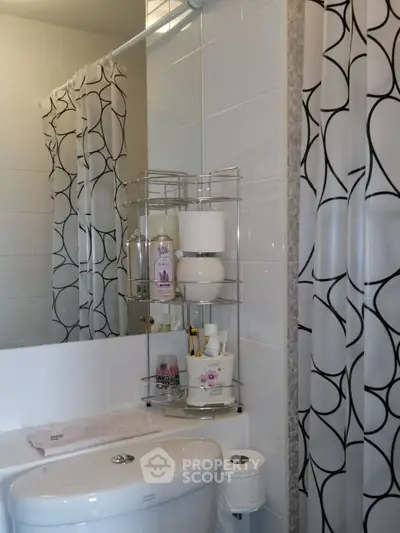 Modern bathroom with stylish shower curtain and organized shelving