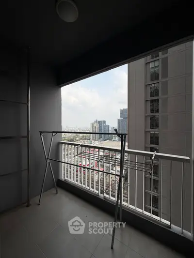 Spacious balcony with city view in modern high-rise apartment
