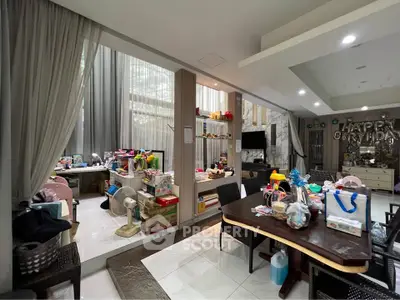 Spacious living room with high ceilings and modern decor, perfect for family gatherings.
