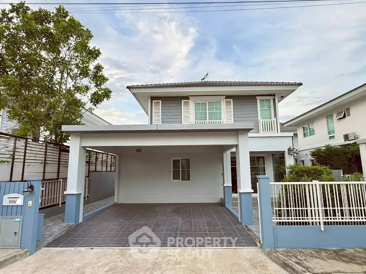 Charming two-story house with spacious driveway and modern exterior design in a serene neighborhood.