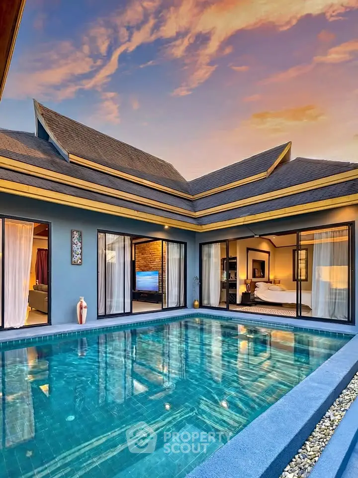 Luxurious villa with private pool and elegant interior design at sunset.
