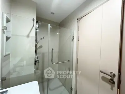 Modern bathroom with glass shower enclosure and sleek fixtures