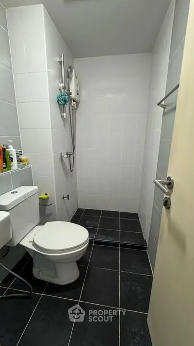 Modern bathroom with sleek black tiles and white fixtures