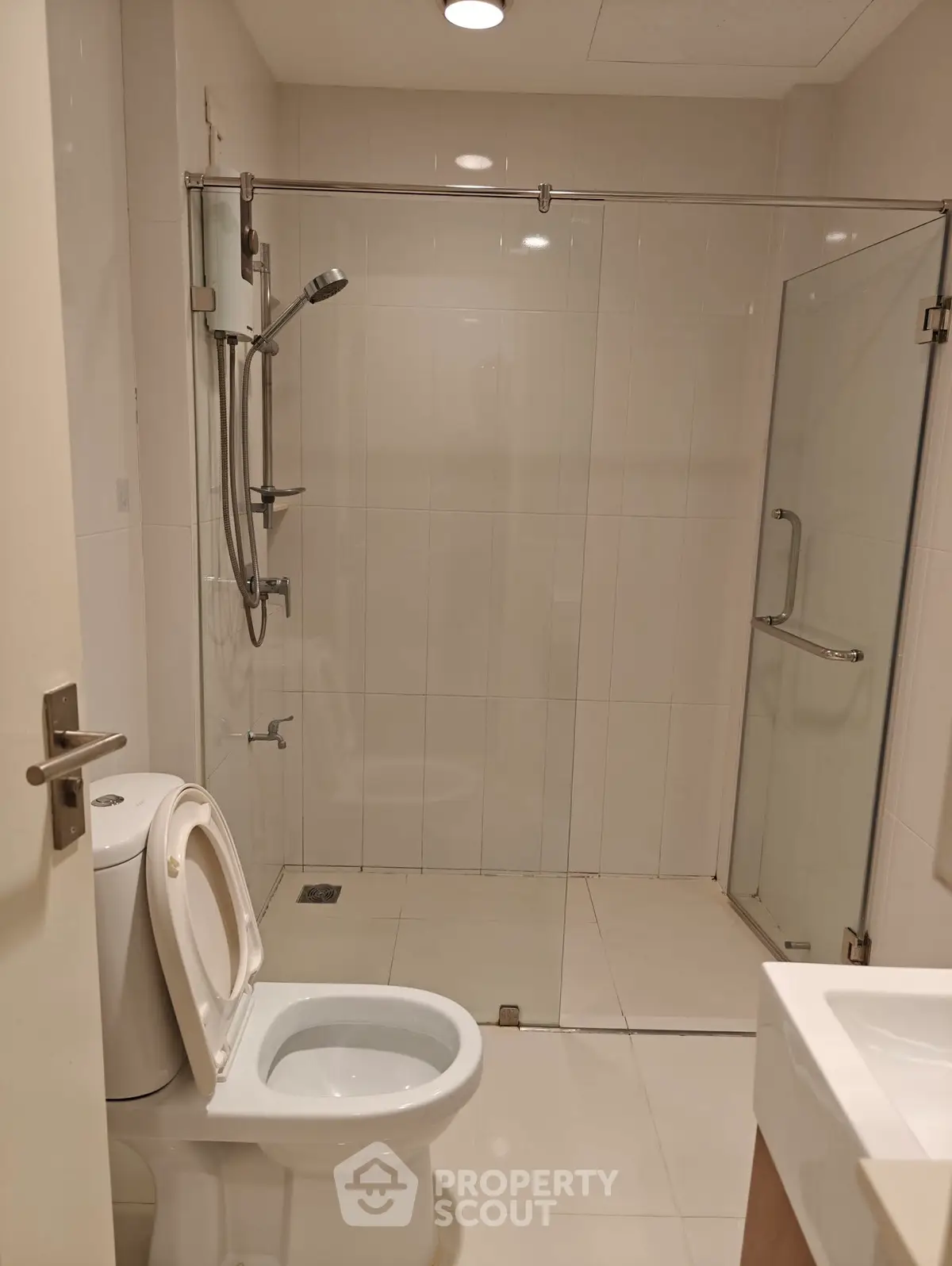 Modern bathroom with glass shower enclosure and sleek fixtures