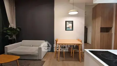 Modern living room with cozy sofa, dining table, and stylish decor in a contemporary apartment.