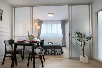 Modern studio apartment with sliding glass doors and elegant dining area