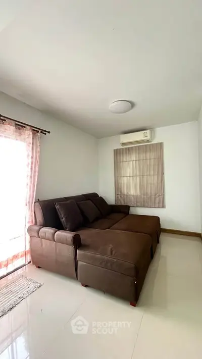 Cozy living room with brown sectional sofa and natural light
