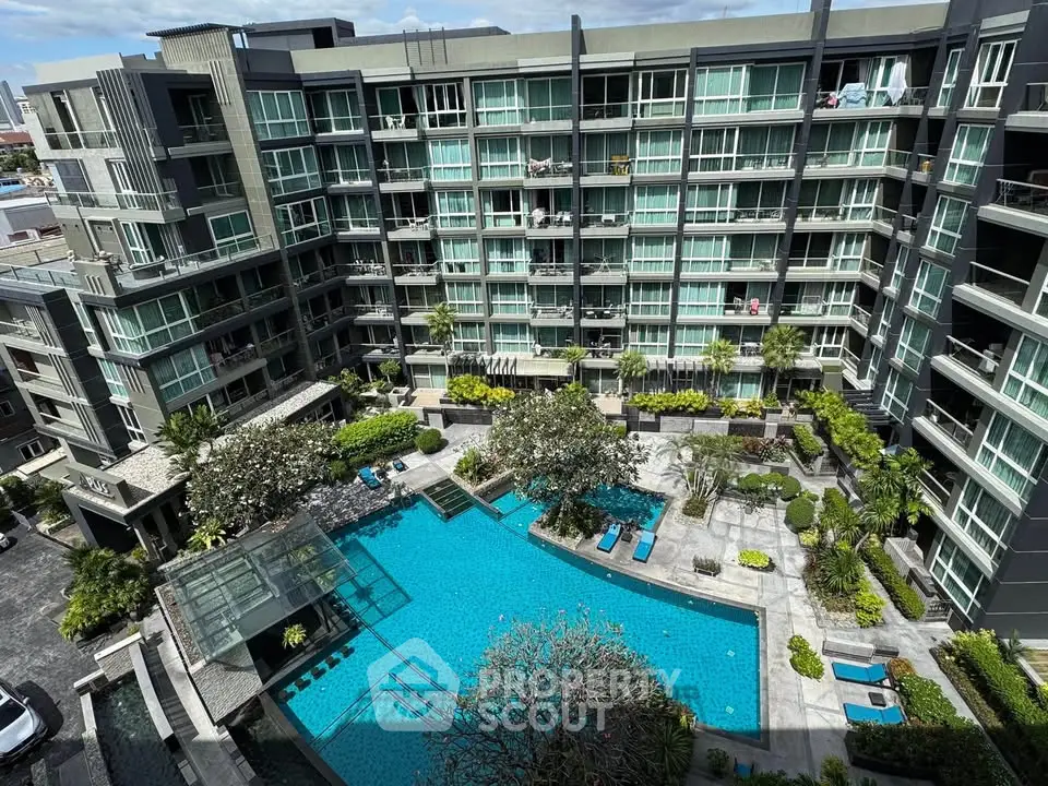 Luxurious condominium with stunning pool and lush garden view