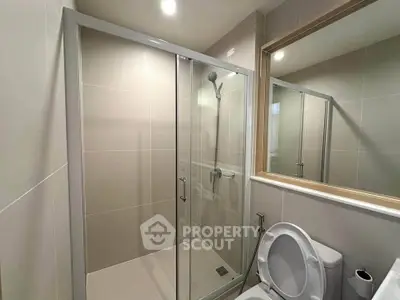 Modern bathroom with glass shower enclosure and sleek design