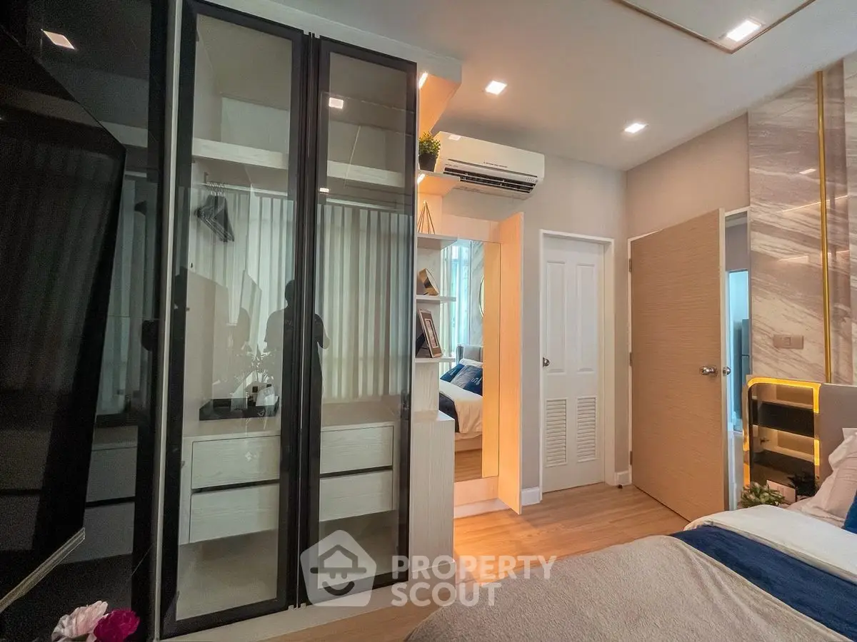 Modern bedroom with sleek wardrobe and cozy decor