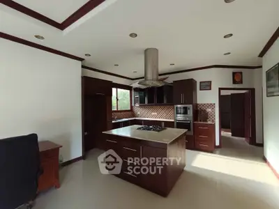 Spacious kitchen with island and modern appliances in elegant home