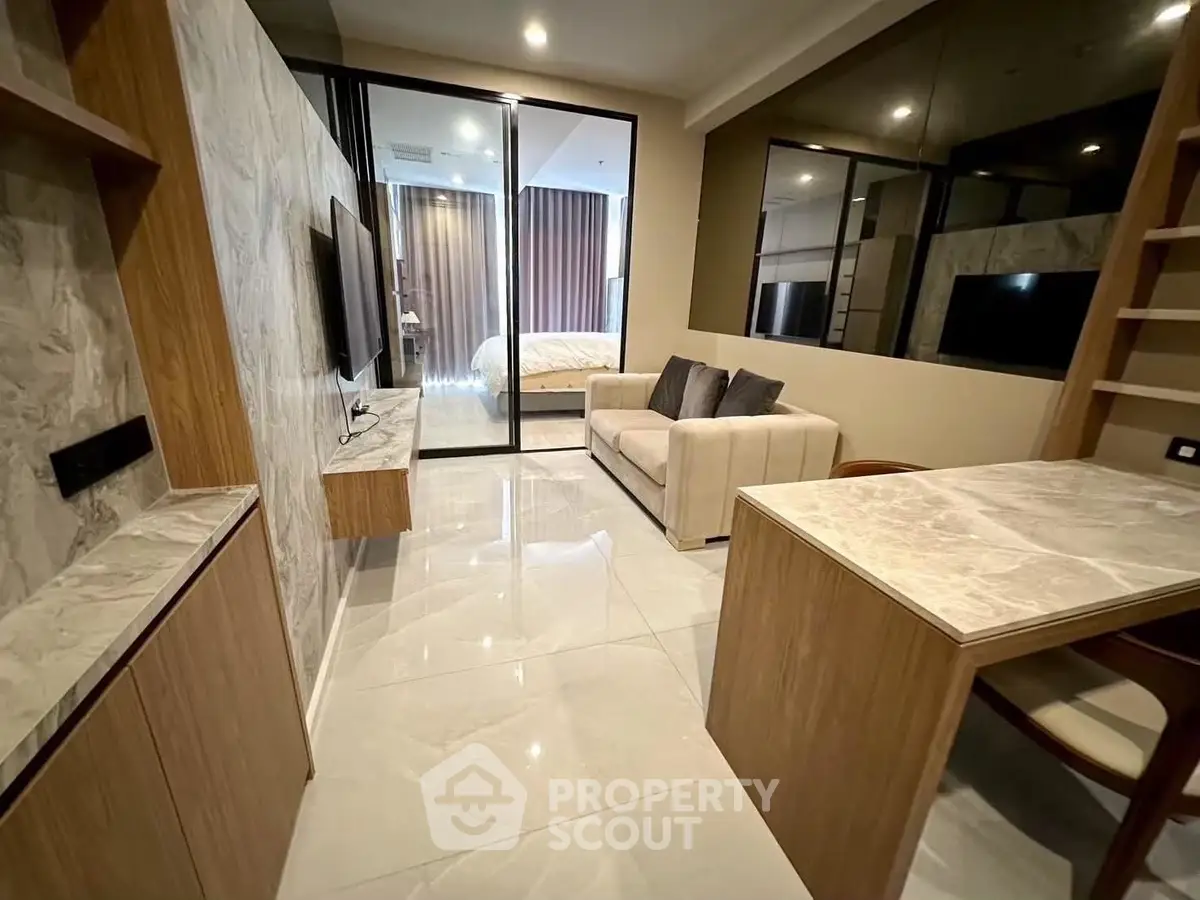 Modern living room with sleek design and open layout, featuring a cozy sofa and stylish decor.