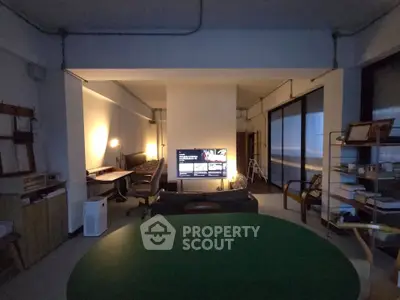 Spacious living room with modern decor and large windows, perfect for relaxation and entertainment.