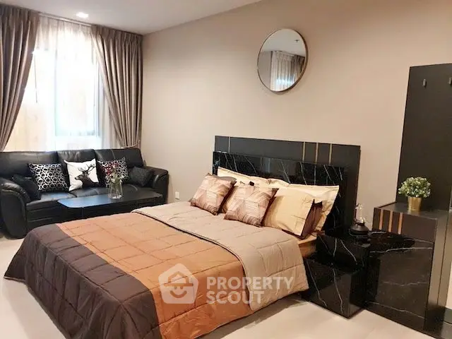 Luxurious bedroom with elegant decor and cozy seating area, perfect for relaxation and comfort.
