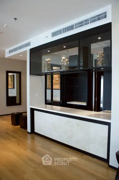 Modern interior with sleek built-in cabinetry and hardwood floors, perfect for stylish living.